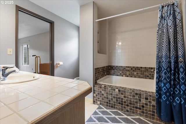 full bathroom featuring vanity and tiled shower / bath