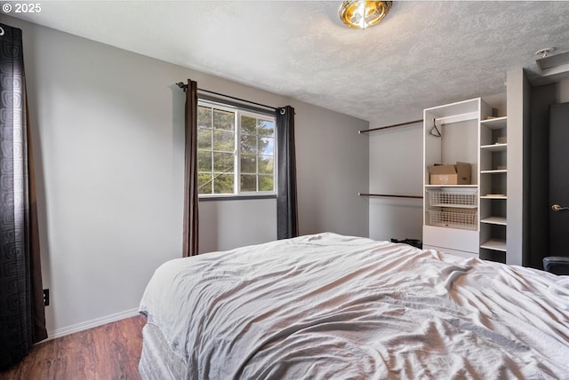 bedroom featuring baseboards and wood finished floors