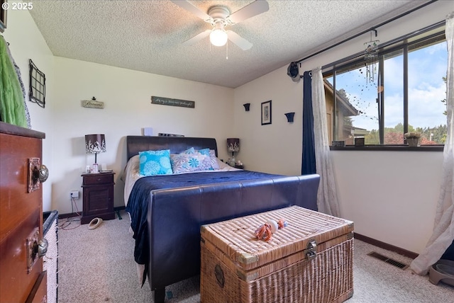 bedroom with visible vents, carpet flooring, and a textured ceiling
