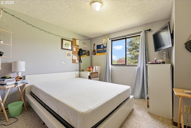 bedroom featuring a textured ceiling and light carpet