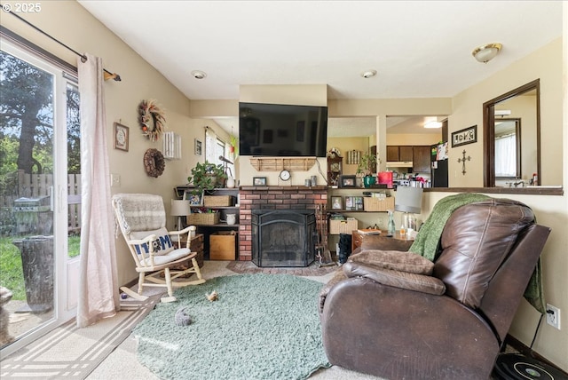 living room featuring carpet floors and a brick fireplace