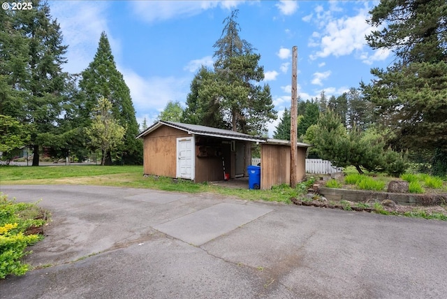 exterior space featuring fence and a shed