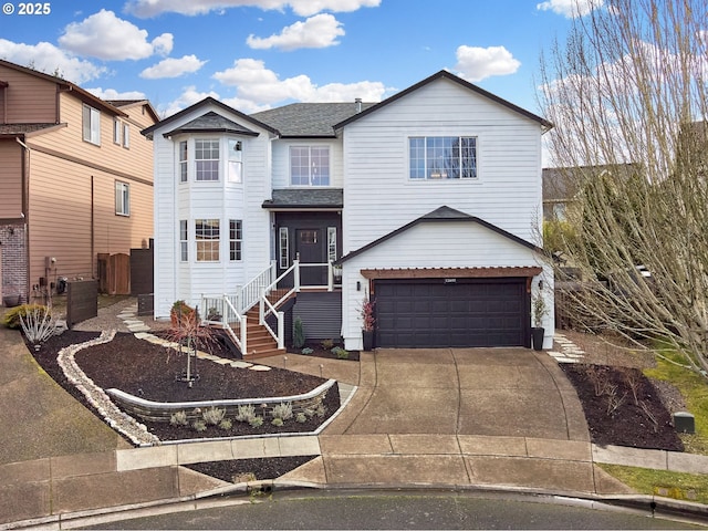 view of front of house with a garage, driveway, and a shingled roof