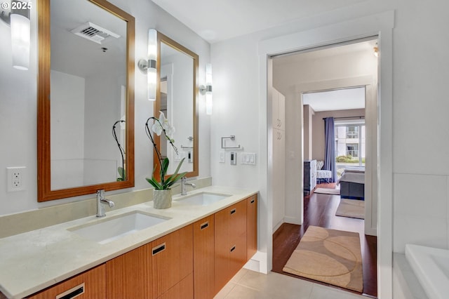 1260 NW Naito Pkwy Unit 103, Portland, OR 97209 - bathroom featuring double vanity, a tub, and tile patterned flooring