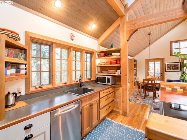 kitchen featuring vaulted ceiling with beams, open shelves, stainless steel appliances, and a sink