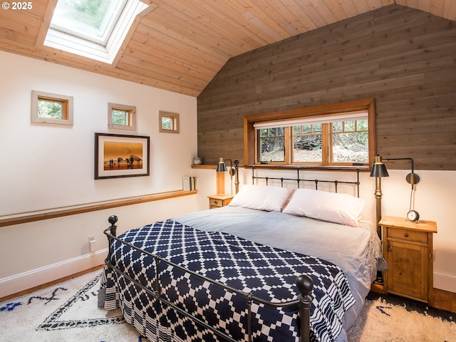 bedroom with vaulted ceiling with skylight, wood ceiling, and baseboards