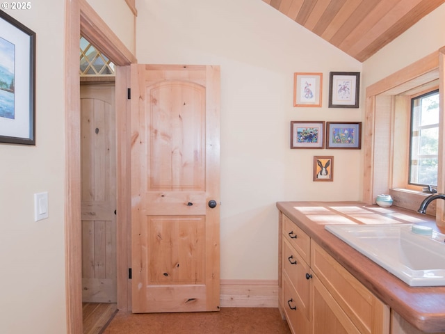 bathroom with vanity and vaulted ceiling