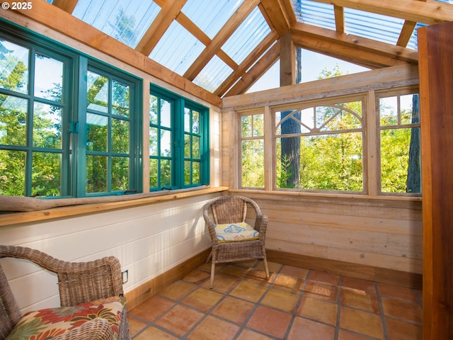 sunroom / solarium featuring vaulted ceiling with beams