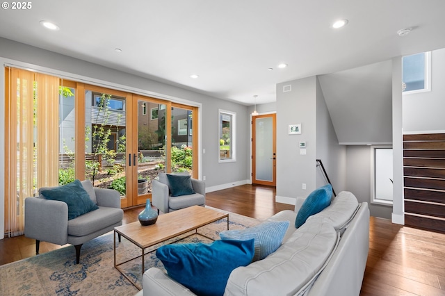 living room featuring visible vents, wood finished floors, stairway, baseboards, and recessed lighting