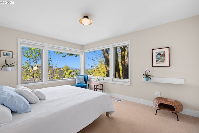 bedroom featuring baseboards, multiple windows, carpet flooring, and visible vents