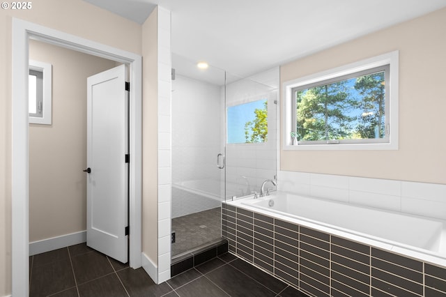 full bath featuring baseboards, tile patterned flooring, a shower stall, and a garden tub