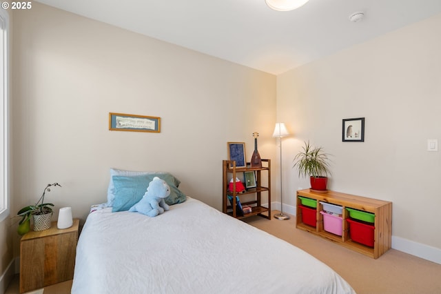 carpeted bedroom featuring baseboards