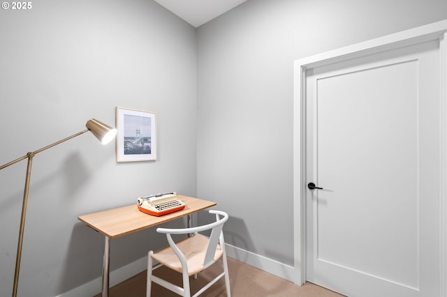 office area with baseboards and light carpet