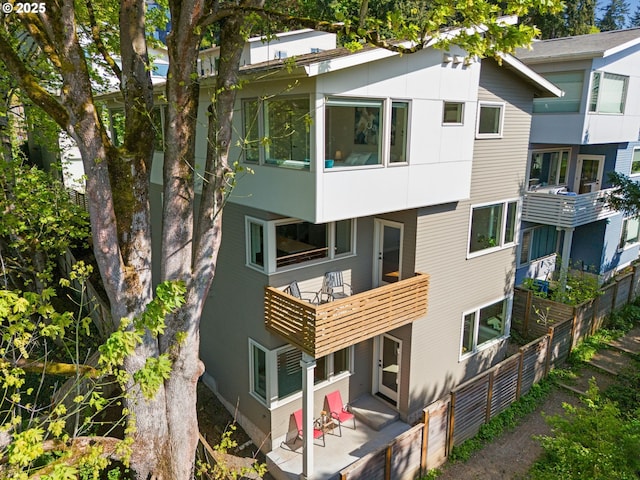 back of house featuring a balcony
