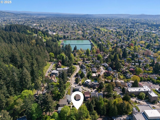 aerial view featuring a water view and a forest view