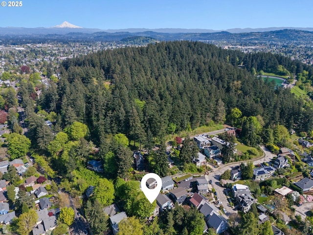 aerial view featuring a mountain view and a wooded view