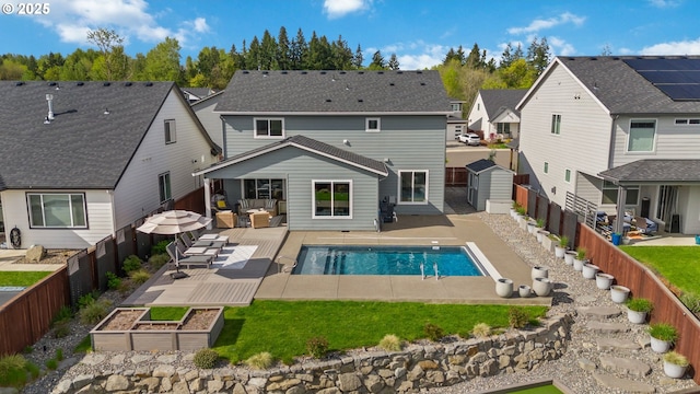 4815 S 12th Cir, Ridgefield, WA 98642 - back of property featuring a fenced backyard, a residential view, a garden, and outdoor lounge area