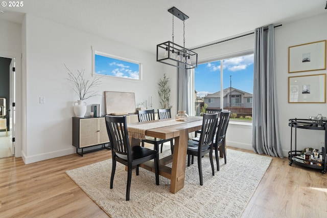 4815 S 12th Cir, Ridgefield, WA 98642 - dining space featuring plenty of natural light, light wood finished floors, a chandelier, and baseboards