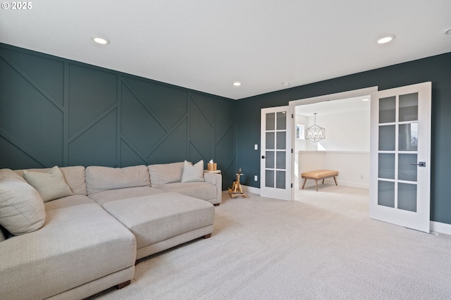 4815 S 12th Cir, Ridgefield, WA 98642 - living room with french doors, light colored carpet, baseboards, a decorative wall, and recessed lighting
