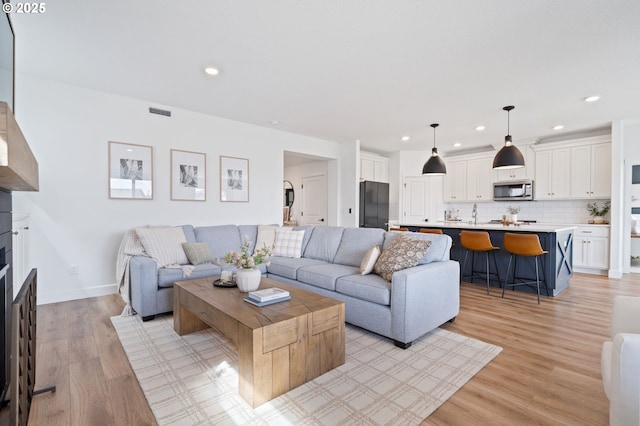 4815 S 12th Cir, Ridgefield, WA 98642 - living room featuring light wood finished floors, recessed lighting, and a fireplace