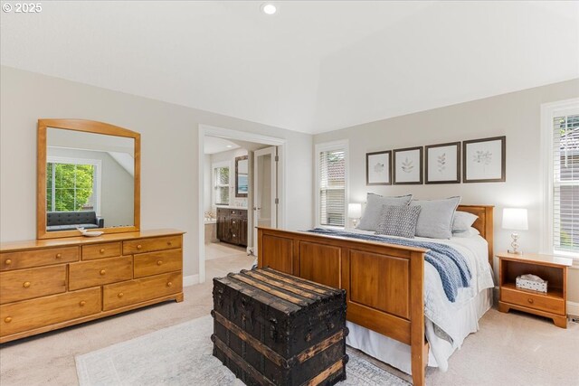 bedroom featuring baseboards, recessed lighting, connected bathroom, and light colored carpet