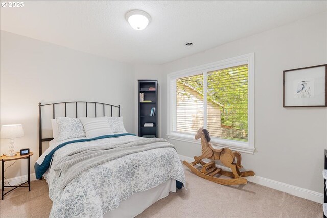 bedroom featuring baseboards and carpet