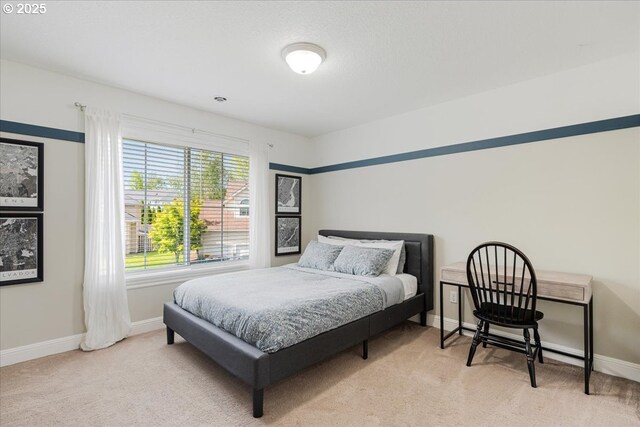 bedroom featuring carpet floors and baseboards