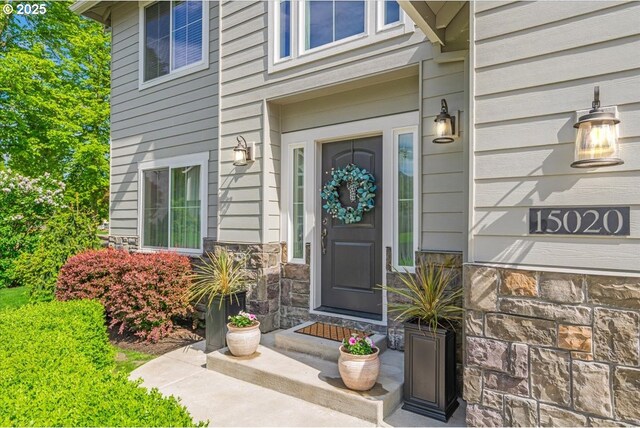 property entrance featuring stone siding