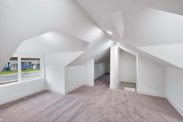 bonus room with baseboards, carpet flooring, and lofted ceiling