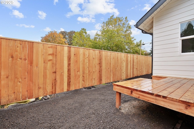 view of yard featuring fence and a wooden deck