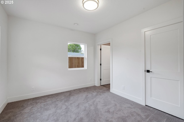 unfurnished bedroom featuring baseboards and carpet