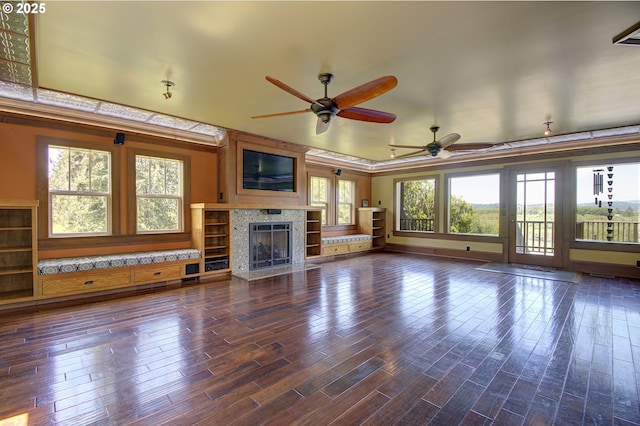 unfurnished living room with dark wood-type flooring and ceiling fan