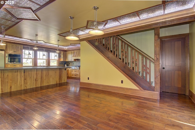 unfurnished living room with sink and dark wood-type flooring