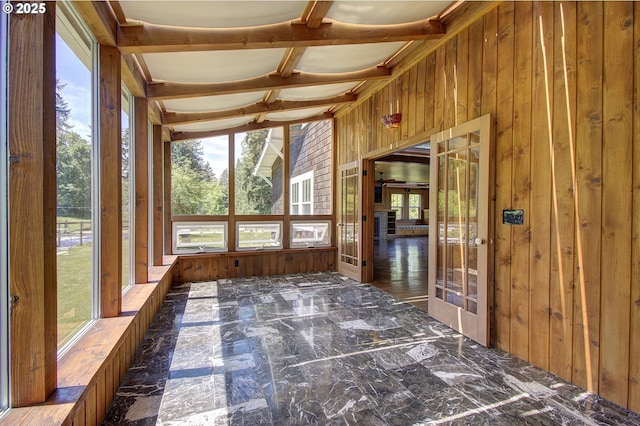 unfurnished sunroom with coffered ceiling and beam ceiling