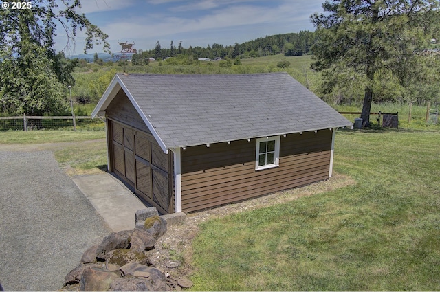 view of outbuilding featuring a lawn