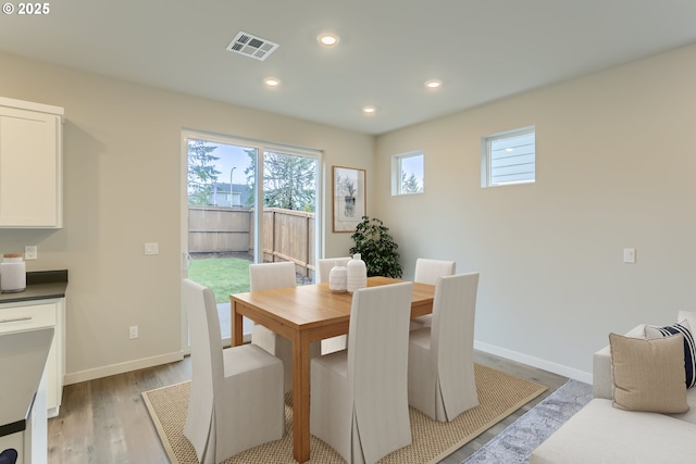 dining room featuring light wood-style flooring, visible vents, baseboards, and recessed lighting