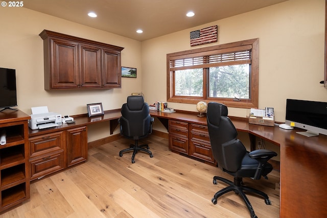 office featuring light wood-style floors, built in desk, and recessed lighting