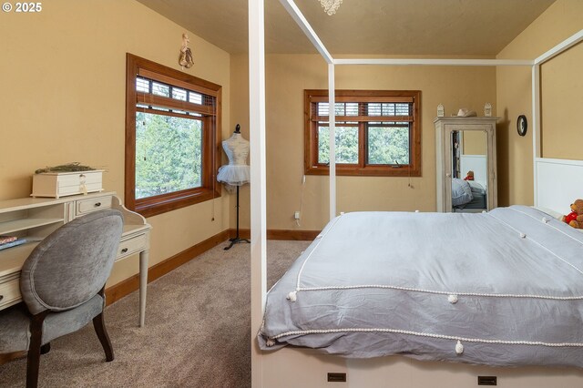 carpeted bedroom featuring baseboards