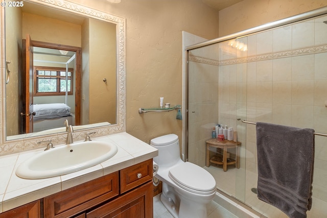 ensuite bathroom featuring ensuite bathroom, a shower stall, toilet, and vanity