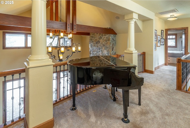 sitting room featuring carpet floors, ornate columns, baseboards, and visible vents