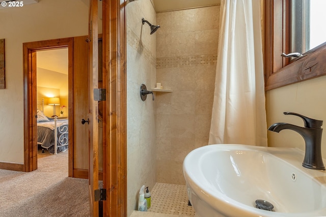 ensuite bathroom with tiled shower, a sink, and ensuite bath