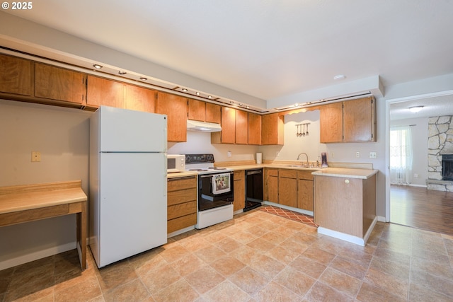 2330 SE Brookwood Ave Unit 222, Hillsboro, OR 97123 - kitchen with white appliances, under cabinet range hood, a sink, light countertops, and brown cabinetry