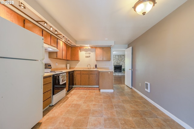 2330 SE Brookwood Ave Unit 222, Hillsboro, OR 97123 - kitchen with white appliances, a sink, light countertops, under cabinet range hood, and brown cabinets