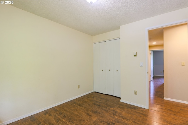2330 SE Brookwood Ave Unit 222, Hillsboro, OR 97123 - unfurnished bedroom with wood finished floors, baseboards, and a closet