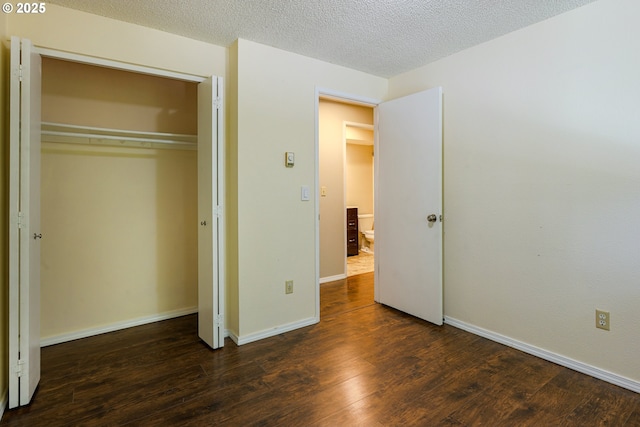 2330 SE Brookwood Ave Unit 222, Hillsboro, OR 97123 - unfurnished bedroom featuring wood finished floors, a closet, baseboards, and a textured ceiling