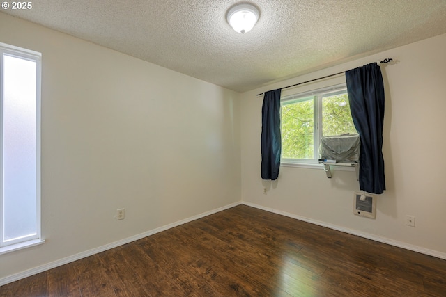 2330 SE Brookwood Ave Unit 222, Hillsboro, OR 97123 - unfurnished room with dark wood finished floors, a textured ceiling, baseboards, and heating unit