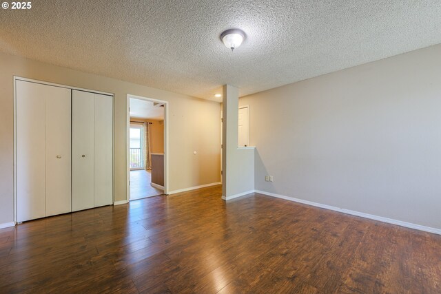 2330 SE Brookwood Ave Unit 222, Hillsboro, OR 97123 - unfurnished bedroom with wood finished floors, baseboards, a textured ceiling, and a closet