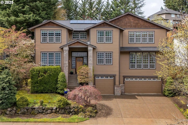14411 SW 128th Pl, Tigard, OR 97224 - view of front of property with concrete driveway, an attached garage, and roof mounted solar panels