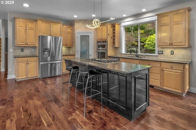 14411 SW 128th Pl, Tigard, OR 97224 - kitchen with tasteful backsplash, dark wood-type flooring, a breakfast bar area, appliances with stainless steel finishes, and a sink