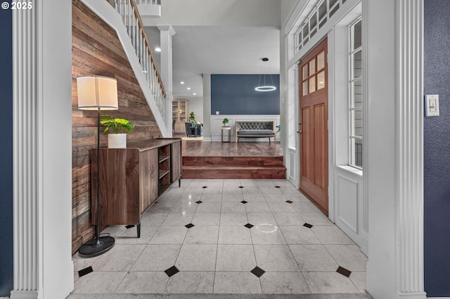 14411 SW 128th Pl, Tigard, OR 97224 - entryway featuring wood walls, light tile patterned flooring, decorative columns, and stairs